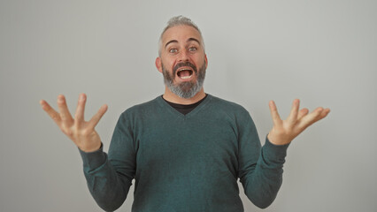 Excited bearded man in green sweater gesturing with hands against a white background