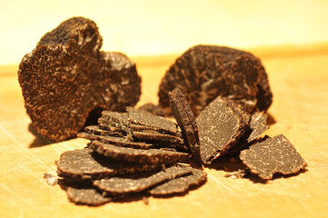 black truffles on a chopping board