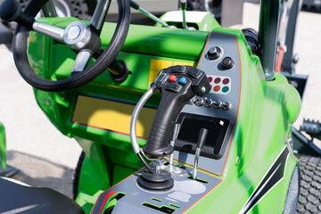 Steering wheel and joystick of tractor.
