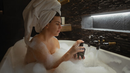 Relaxed woman enjoying luxury bubble bath in a modern bathroom at home