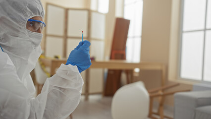 A person in a hazmat suit examines evidence in a sunny, modern living room, suggesting a crime...