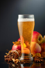 Apple cider in high glass on a black background.