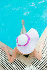 A A blower with a hat lies in a relaxation pool. On a journey