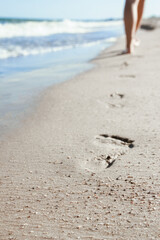 stylish beautiful legs with traces of the sea in the summer on the nature