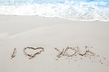 beautiful drawings inscription on the sand of the sea in the summer on the nature