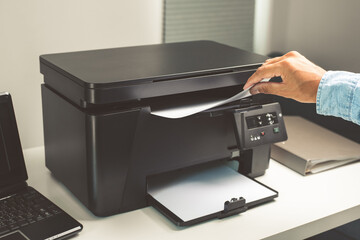 The man using the laser printer.