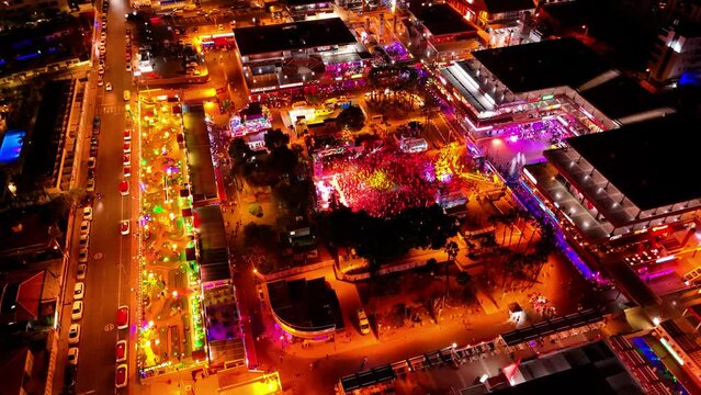A short night-time drone video captures the lights of Maspalomas, Spain. The city glows like a gem, with bustling streets and bright lights creating a magical atmosphere under the starry sky.