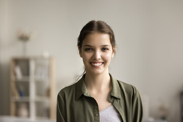 Happy beautiful teenager girl home indoor head shot portrait. Cheerful pretty high school student,...