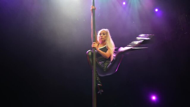 Beautiful blond girl pole dance.