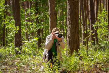 Photographer in the spring forest.
The photographer has chosen a subject and is preparing to...