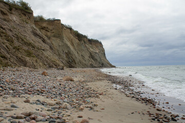 bay of the Baltic Sea with sandy cliffs in cloudy weather