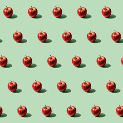 Isometric pattern of isolated group of fresh red apples with drops on a flat clean green pastel backdrop surface. Hard light shot