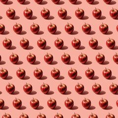 Isometric pattern of isolated group of fresh red apples with drops on a flat clean red pastel backdrop surface. Hard light shot