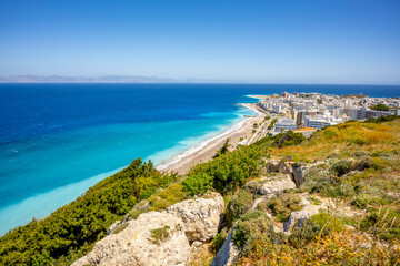 Aegean beach with sunshades in city of Rhodes (Rhodes, Greece)