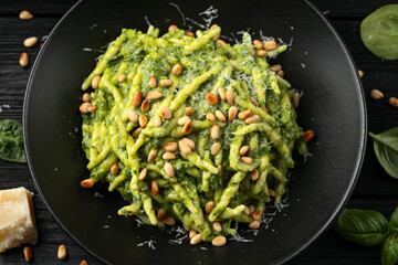 Trofie pasta with creamy spinach sauce and toasted pine nuts