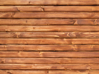Naklejka premium Close-up texture of wooden boards brown tones with cracks.