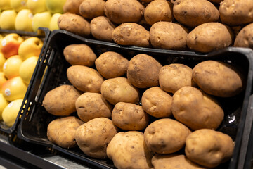 Collection of potatoes on a sale on a counter of market. bio vegetables sold on market stall....
