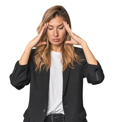 Young businesswoman in a suit touching temples and having headache.