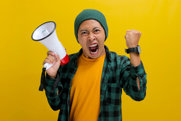 Angry Young Asian man shouts into a megaphone against a yellow background