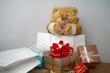 Teddy bear with boxes, gifts.