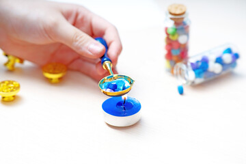 Child Hand melting spoon dissolving multicolored sealing wax