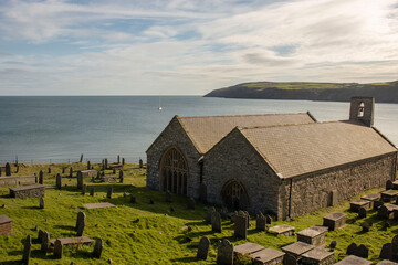St. Hywyn's Church, Aberdaron, Wales in evening sunlight. An important place of pilgrimage which is...