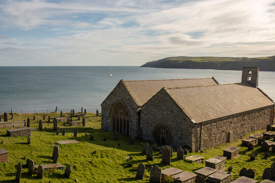 St. Hywyn's Church, Aberdaron, Wales in evening sunlight. An important place of pilgrimage which is part of the North Wales Pilgrim's Way.