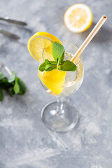Trendy Elderflower Hugo Spritz Cocktail and Bar Accessories on Gray Concrete Background
