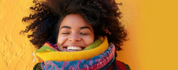 A smiling woman with a colorful scarf poses against a winter scene, exuding warmth and happiness.