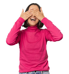 Young Caucasian woman with short hair covers eyes with hands, smiles broadly waiting for a surprise.