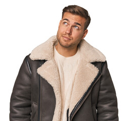 Young caucasian man dreaming of achieving goals and purposes