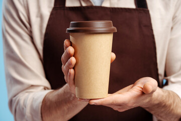 Close up of barista handing a cup of hot coffee isolated over white background