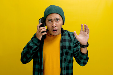 Shocked Asian man, dressed in a beanie hat and casual shirt, engages in a conversation on his...