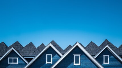 Suburban home rooflines against a clear blue sky