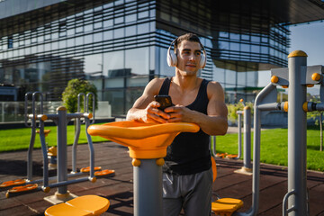 One man caucasian young male stand at outdoor open training park gym