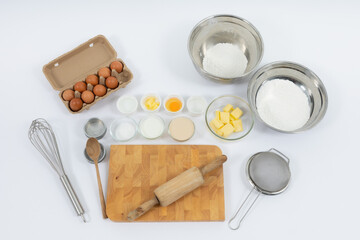 Egg tart, eggs and other ingredients and tools on white background