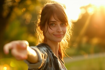 Young smiling woman gives hand (follow me) in the background of a sunset in the city