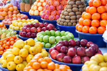 Various types of fresh fruits neatly arrange the grocery store. Apple, Orange, Pineapple, Lemon, Kiwi, Pears