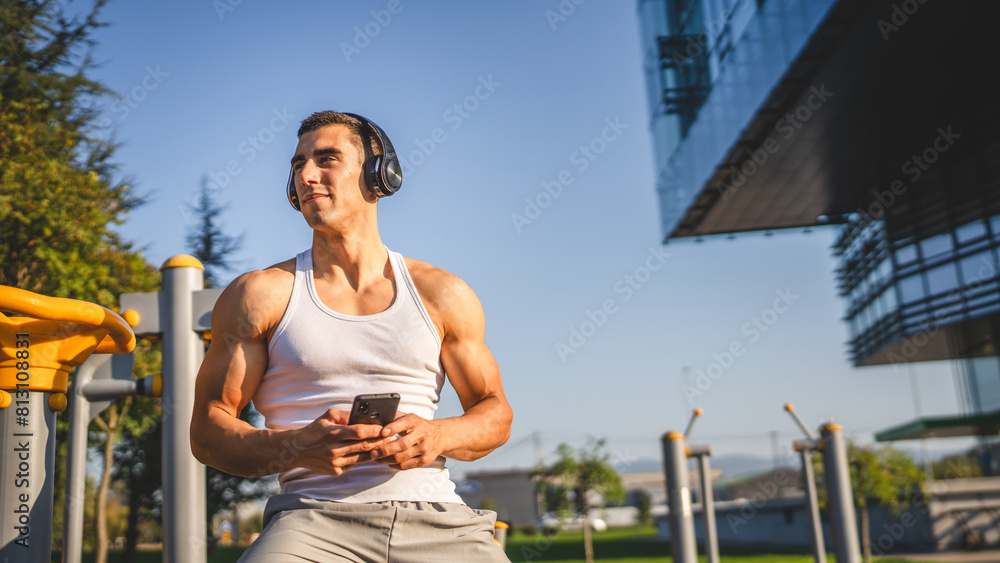 Poster man young male use mobile phone at outdoor open training park gym