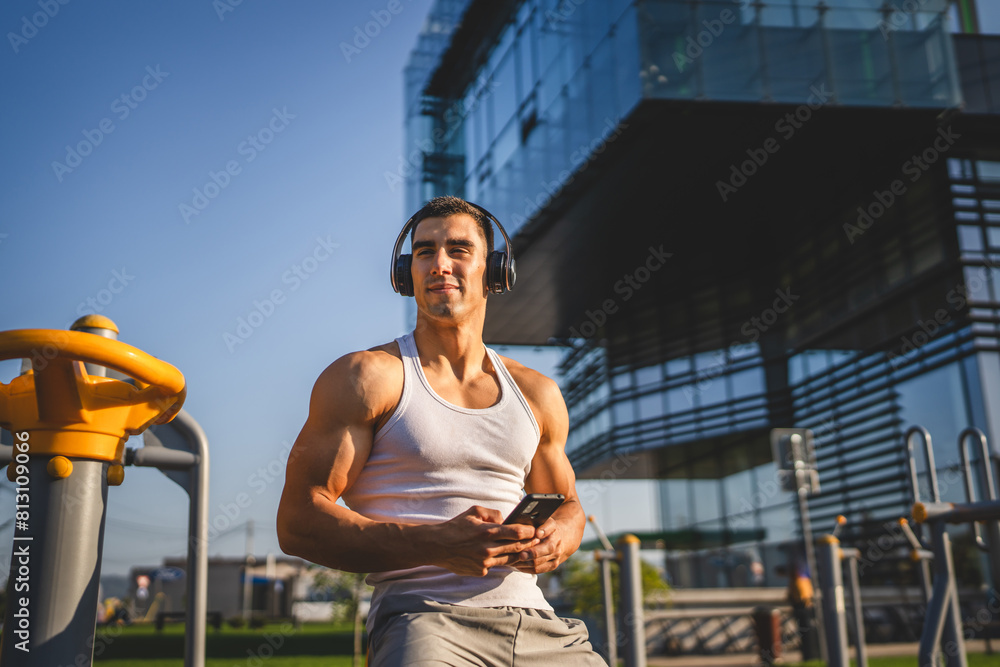 Poster man young male use mobile phone at outdoor open training park gym