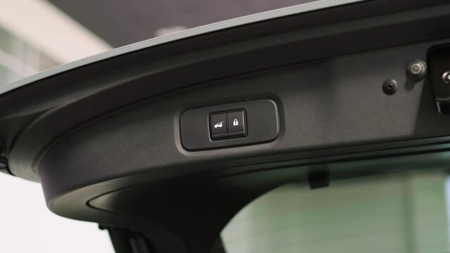 Close-up of the closing trunk of a modern car. Concept of travel, car service and automotive technology.