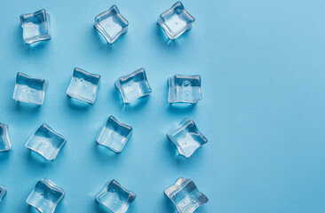 Ice cubes on bright blue background. Minimal summer drink concept. Flat lay.