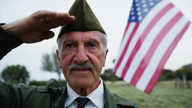 Veteran Salutes The American Flag On Memorial Day In The Cemetery Outdoor