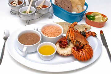 Plate of lobster tails, grilled lobster served with rice, beans, Mexican sauces and bread