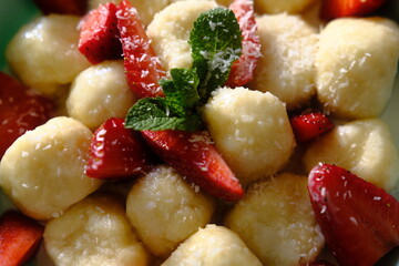 Delicious lazy dumplings with berries, sour cream, mint leaves. Perfect for culinary projects,...