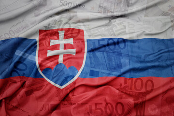 Fototapeta premium waving colorful national flag of slovakia on a euro money banknotes background. finance concept.