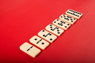 Fototapeta na wymiar Dominoes with red background, copy space and various angles