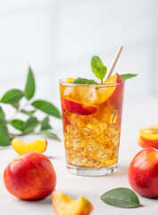 Refreshing peach iced mint tea close up. The concept of a healthy homemade cold summer drink