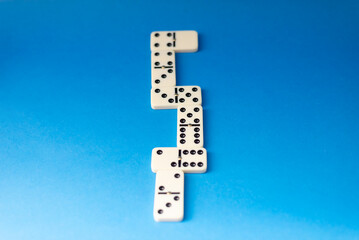 Connected dominoes on a blue background.