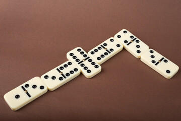 Dominoes on a brown background. White